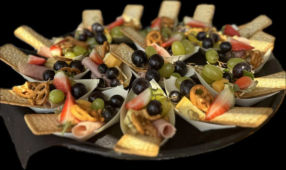 Assorted savoury canapés on a black platter
