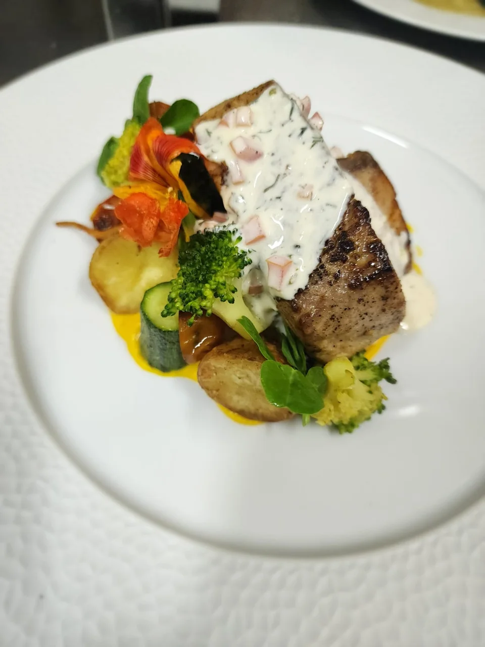 Plated main course with vegetables and sauce